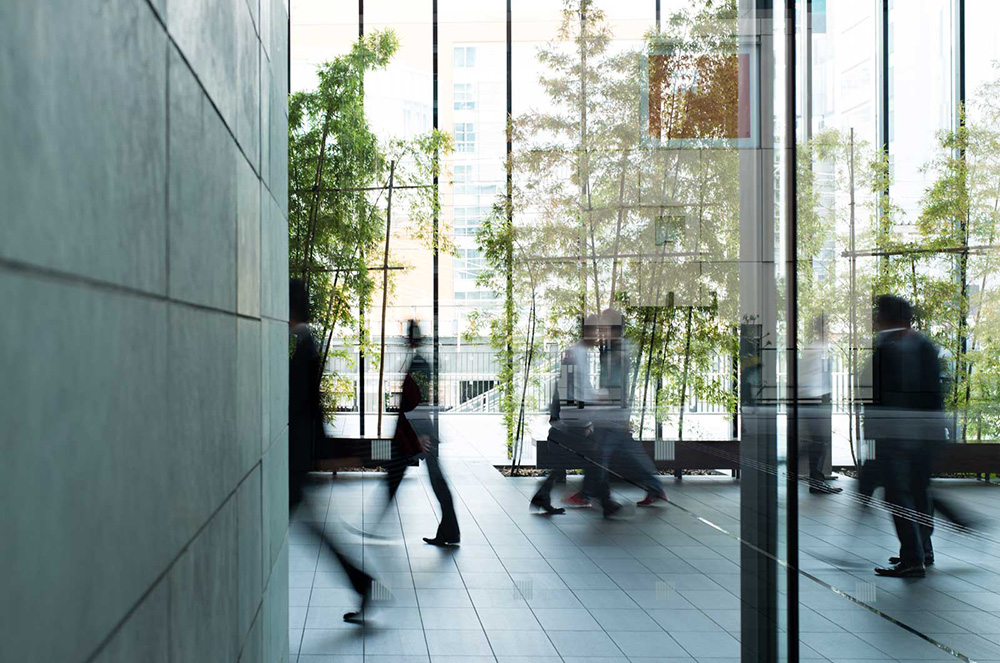 Business-person-walking-in-a-urban-building