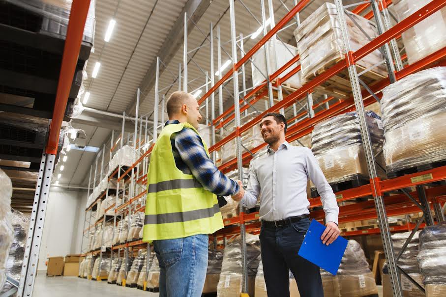 Worker-and-businessmen-with-clipboard-at-warehouse